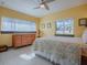 Bedroom with dresser, window seat, and yellow walls at 908 N Lakeshore Blvd, Howey In The Hills, FL 34737