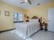 Bedroom with window, nightstand, and ceiling fan at 908 N Lakeshore Blvd, Howey In The Hills, FL 34737