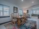 Bright dining room with wooden table, seating for six, and colorful rug at 908 N Lakeshore Blvd, Howey In The Hills, FL 34737