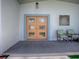 Front entry with double doors, light blue trim and two chairs at 908 N Lakeshore Blvd, Howey In The Hills, FL 34737