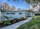 Landscaped walkway to the front door of a mid-century home at 908 N Lakeshore Blvd, Howey In The Hills, FL 34737