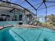 Inviting screened pool with brick deck at 908 N Lakeshore Blvd, Howey In The Hills, FL 34737