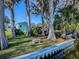 Private seawall with a bench and lush landscaping at 908 N Lakeshore Blvd, Howey In The Hills, FL 34737