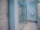 Modern shower with glass enclosure and blue mosaic tile at 908 N Lakeshore Blvd, Howey In The Hills, FL 34737