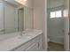 Simple bathroom with white vanity and a bathtub at 10049 Ballast Dr, Orlando, FL 32827