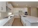 White kitchen with large island and stainless steel appliances at 10049 Ballast Dr, Orlando, FL 32827