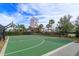 Outdoor basketball court that includes palm tree landscaping and a fence surrounding the entire area for added privacy at 10079 Gobat Aly, Orlando, FL 32827