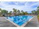 Community swimming pool with clearly marked lanes and lounge area that includes a volleyball court for recreational activities at 10079 Gobat Aly, Orlando, FL 32827