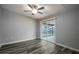 Spacious bedroom with sliding glass doors to the patio and ceiling fan at 1015 Stucki Ter, Winter Garden, FL 34787