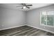 Spacious bedroom with gray walls, wood-look floors, and a ceiling fan at 1015 Stucki Ter, Winter Garden, FL 34787