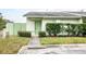 Well-maintained townhouse with green exterior, landscaping, and walkway at 1015 Stucki Ter, Winter Garden, FL 34787