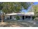 Single-story home featuring a covered porch and well-maintained exterior at 11221 Lake Eustis Dr, Leesburg, FL 34788