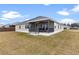 House exterior with large backyard and screened porch at 11272 Stewart Loop, Oxford, FL 34484