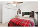 Charming bedroom with plaid bedding and armchair at 11272 Stewart Loop, Oxford, FL 34484