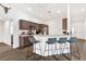 Modern kitchen with dark brown cabinets and breakfast bar at 11272 Stewart Loop, Oxford, FL 34484