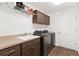 Well-equipped laundry room with cabinets and shelving at 11272 Stewart Loop, Oxford, FL 34484