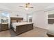 Large main bedroom with king-size bed and ceiling fan at 11272 Stewart Loop, Oxford, FL 34484