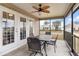 Relaxing screened porch with patio furniture and ceiling fan at 11272 Stewart Loop, Oxford, FL 34484