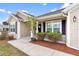 Sidewalk leading to the house entrance with landscaping at 11272 Stewart Loop, Oxford, FL 34484