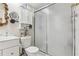 Bathroom featuring a shower with glass doors, and a toilet with white shelving above it at 118 Shomate Dr, Longwood, FL 32750