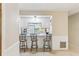 Bright kitchenette area with breakfast bar seating and crisp white cabinets at 118 Shomate Dr, Longwood, FL 32750