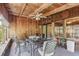 The sunroom's wood paneling and natural light create a warm, inviting atmosphere for dining or lounging at 118 Shomate Dr, Longwood, FL 32750