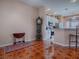 Dining area with hardwood-style flooring, a grandfather clock, and kitchen views at 12060 Se 176Th Loop, Summerfield, FL 34491