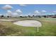 Landscaped golf course with sand traps and homes at 12060 Se 176Th Loop, Summerfield, FL 34491