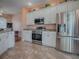 Modern kitchen with stainless steel appliances and granite countertops at 12060 Se 176Th Loop, Summerfield, FL 34491