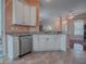 White cabinets, granite counters, and stainless steel dishwasher at 12060 Se 176Th Loop, Summerfield, FL 34491