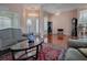 Living room with entryway view, comfortable seating and decorative accents at 12060 Se 176Th Loop, Summerfield, FL 34491