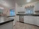 Well-equipped kitchen with white cabinets and granite countertops at 1218 Augustine Dr, Lady Lake, FL 32159