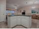 Large kitchen island with granite countertops and seating for three at 1218 Augustine Dr, Lady Lake, FL 32159