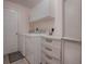 Laundry room with washer, dryer, and storage cabinets at 1218 Augustine Dr, Lady Lake, FL 32159