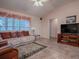 Living room boasts comfortable seating and large windows at 1218 Augustine Dr, The Villages, FL 32159