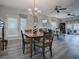 Bright dining room with wood table and chairs, adjacent to living room at 1235 Avenida De Las Casas, The Villages, FL 32159