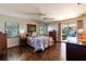 Bedroom with hardwood floors and sliding glass doors to the pool area at 12430 Blue Heron Way, Leesburg, FL 34788