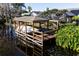 Covered boat dock with a boat on a canal at 12430 Blue Heron Way, Leesburg, FL 34788