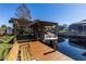 Covered boat lift with a wooden pergola providing shade at 12430 Blue Heron Way, Leesburg, FL 34788