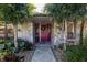 Welcoming entryway with a charming red door and stone accents at 12430 Blue Heron Way, Leesburg, FL 34788