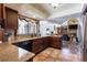 Kitchen features granite counters, dark wood cabinets, and views into the living room at 12430 Blue Heron Way, Leesburg, FL 34788