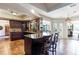 Spacious kitchen with dark wood cabinets and granite countertops at 12430 Blue Heron Way, Leesburg, FL 34788