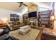 Living room with stone fireplace and built-in shelving at 12430 Blue Heron Way, Leesburg, FL 34788