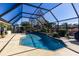 Enclosed pool area with a patio and lush landscaping at 12430 Blue Heron Way, Leesburg, FL 34788