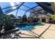 Enclosed pool area with a patio and lush landscaping at 12430 Blue Heron Way, Leesburg, FL 34788