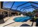 Enclosed pool and patio with solar panels visible at 12430 Blue Heron Way, Leesburg, FL 34788