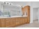 Double vanity bathroom with wood cabinets and large mirror at 12592 Se 97Th Terrace Rd, Summerfield, FL 34491