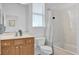 Clean bathroom with shower/tub combo, wood vanity, and white toilet at 12592 Se 97Th Terrace Rd, Summerfield, FL 34491