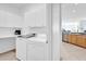 Bright laundry room with built-in cabinets at 12592 Se 97Th Terrace Rd, Summerfield, FL 34491