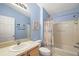 Bathroom with tub shower combination and light blue walls at 1280 Mount Vernon Way, The Villages, FL 32162